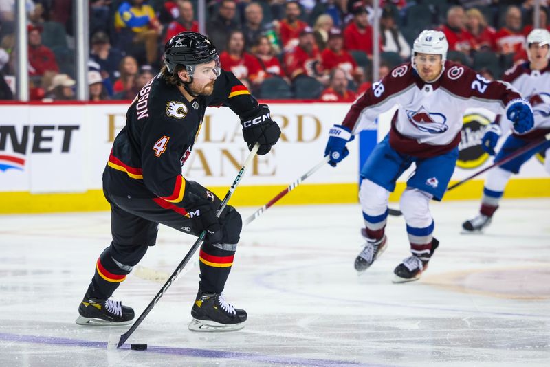 Mar 12, 2024; Calgary, Alberta, CAN; Calgary Flames defenseman Rasmus Andersson (4) controls the puck against the Colorado Avalanche during the third period at Scotiabank Saddledome. Mandatory Credit: Sergei Belski-USA TODAY Sports