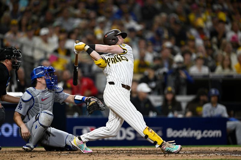 Oct 8, 2024; San Diego, California, USA; San Diego Padres first baseman Jake Cronenworth (9) singles in the fourth inning against the Los Angeles Dodgers during game three of the NLDS for the 2024 MLB Playoffs at Petco Park.  Mandatory Credit: Denis Poroy-Imagn Images