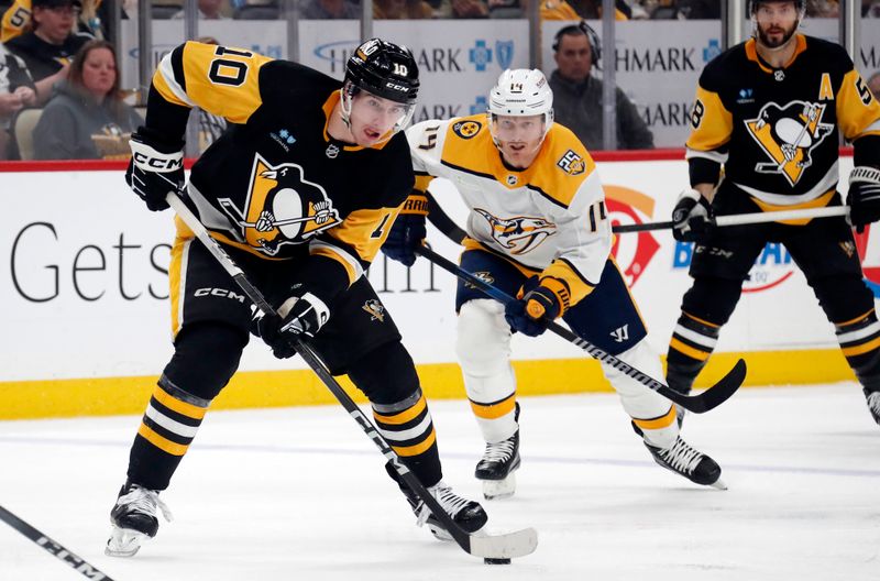 Apr 15, 2024; Pittsburgh, Pennsylvania, USA;  Pittsburgh Penguins left wing Drew O'Connor (10) moves the puck against the Nashville Predators during the third period at PPG Paints Arena. The Penguins won 4-2. Mandatory Credit: Charles LeClaire-USA TODAY Sports