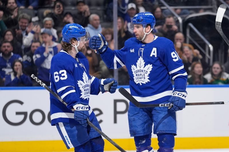 Jan 19, 2026; Toronto, Ontario, CAN; Toronto Maple Leafs forward John Tavares (91) celebrates with forward Matias Maccelli (63) after scoring a goal against the Minnesota Wild during the first period at Scotiabank Arena. Mandatory Credit: John E. Sokolowski-Imagn Images