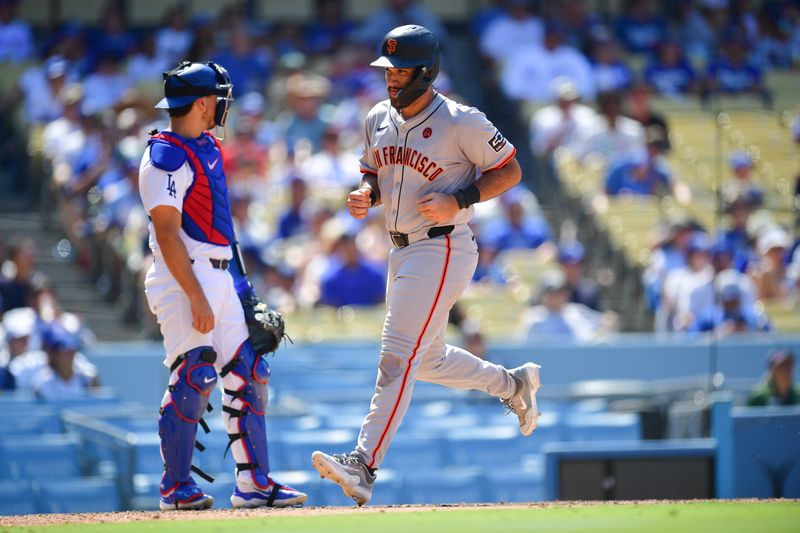 Jul 25, 2024; Los Angeles, California, USA; San Francisco Giants first baseman David Villar (32) scores a run against the Los Angeles Dodgers during the eighth inning at Dodger Stadium. Mandatory Credit: Gary A. Vasquez-USA TODAY Sports