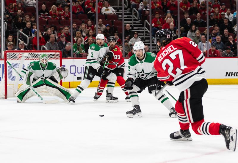 Apr 6, 2024; Chicago, Illinois, USA; Chicago Blackhawks left winger Lukas Reichel (27) shoots the puck against the Dallas Stars during the first period at United Center. Mandatory Credit: Seeger Gray-USA TODAY Sports