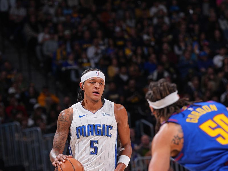 DENVER, CO - JANUARY 5: Paolo Banchero #5 of the Orlando Magic dribbles the ball during the game against the Denver Nuggets on January 5, 2024 at the Ball Arena in Denver, Colorado. NOTE TO USER: User expressly acknowledges and agrees that, by downloading and/or using this Photograph, user is consenting to the terms and conditions of the Getty Images License Agreement. Mandatory Copyright Notice: Copyright 2024 NBAE (Photo by Bart Young/NBAE via Getty Images)