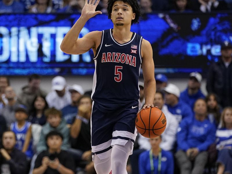 Jan 26, 2026; Provo, Utah, USA; Arizona Wildcats guard Brayden Burries (5) dribbles the ball during the second half against the BYU Cougars at Marriott Center. Mandatory Credit: Aaron Baker-Imagn Images 