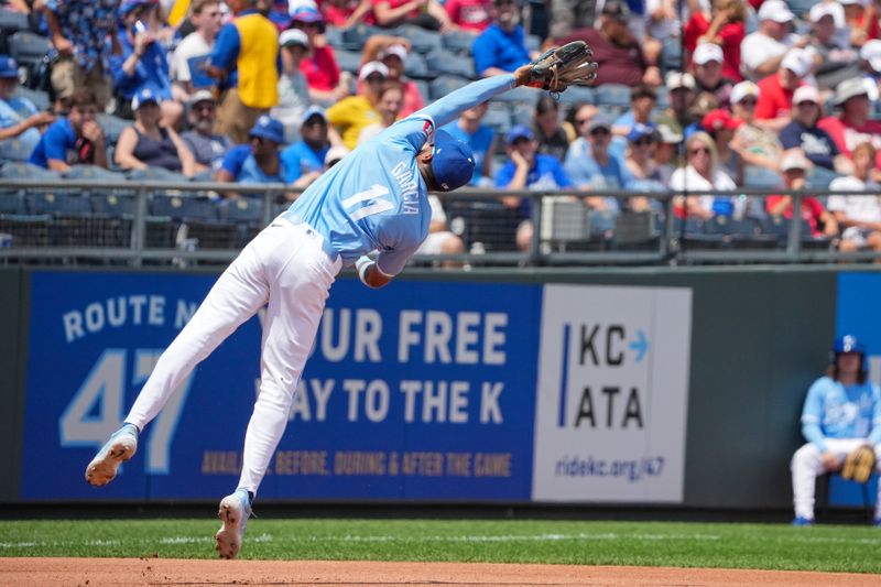 Jul 21, 2024; Kansas City, Missouri, USA;  Kansas City Royals third base Maikel Garcia (11) makes a difficult catch on a pop up against the Chicago White Sox in the fourth inning at Kauffman Stadium. Mandatory Credit: Denny Medley-USA TODAY Sports