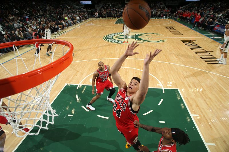 MILWAUKEE, WI - OCTOBER 14: Kenneth Lofton Jr. #34 of the Chicago Bulls rebounds against the Milwaukee Bucks on October 14, 2024 at Fiserv Forum Center in Milwaukee, Wisconsin. NOTE TO USER: User expressly acknowledges and agrees that, by downloading and or using this Photograph, user is consenting to the terms and conditions of the Getty Images License Agreement. Mandatory Copyright Notice: Copyright 2024 NBAE (Photo by Gary Dineen/NBAE via Getty Images).