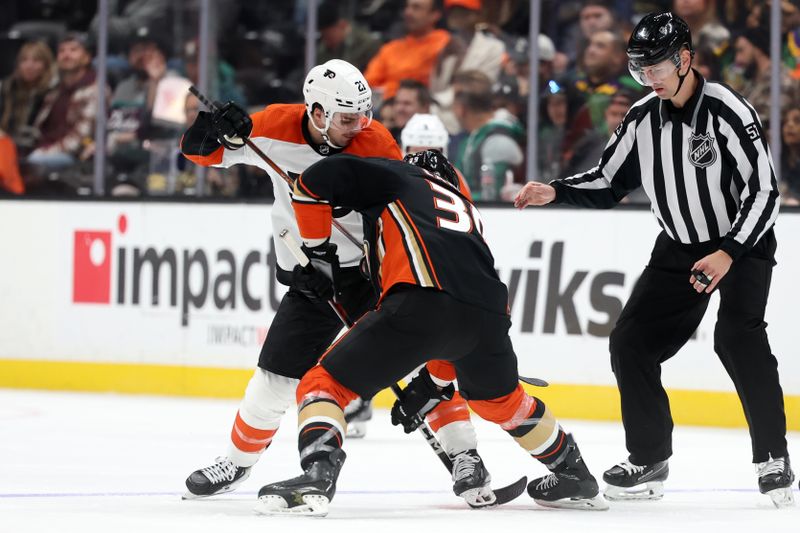 Nov 10, 2023; Anaheim, California, USA; Philadelphia Flyers center Scott Laughton (21) and Anaheim Ducks center Sam Carrick (39) fight for the puck during the third period at Honda Center. Mandatory Credit: Kiyoshi Mio-USA TODAY Sports