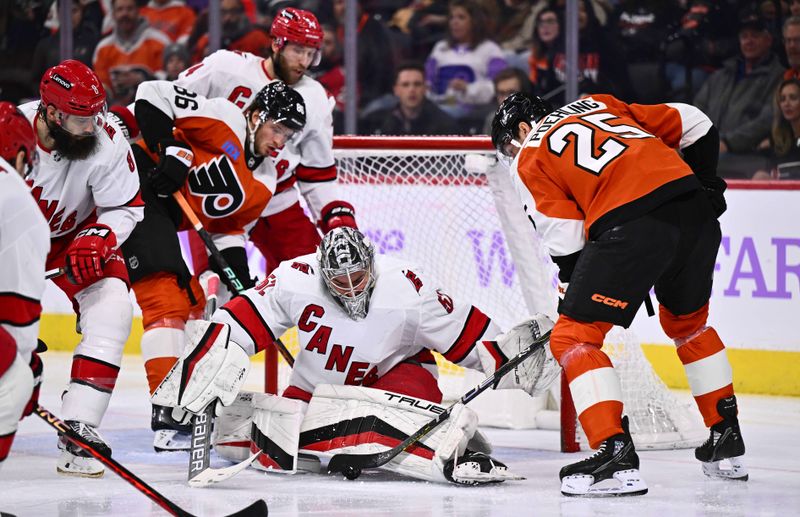 Nov 28, 2023; Philadelphia, Pennsylvania, USA; Carolina Hurricanes goalie Pyotr Kochetkov (52) makes a save against Philadelphia Flyers center Ryan Poehling (25) in the second period at Wells Fargo Center. Mandatory Credit: Kyle Ross-USA TODAY Sports