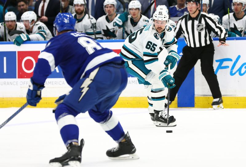 Feb 7, 2023; Tampa, Florida, USA; San Jose Sharks defenseman Erik Karlsson (65) skates with the puck as Tampa Bay Lightning defenseman Erik Cernak (81) defends during the second period at Amalie Arena. Mandatory Credit: Kim Klement-USA TODAY Sports