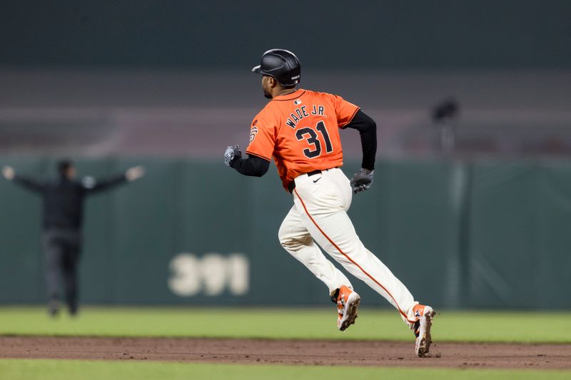 Aug 30, 2024; San Francisco, California, USA; San Francisco Giants first baseman LaMonte Wade Jr. (31) runs to second base for a double against the Miami Marlins during the third inning at Oracle Park. Mandatory Credit: John Hefti-USA TODAY Sports