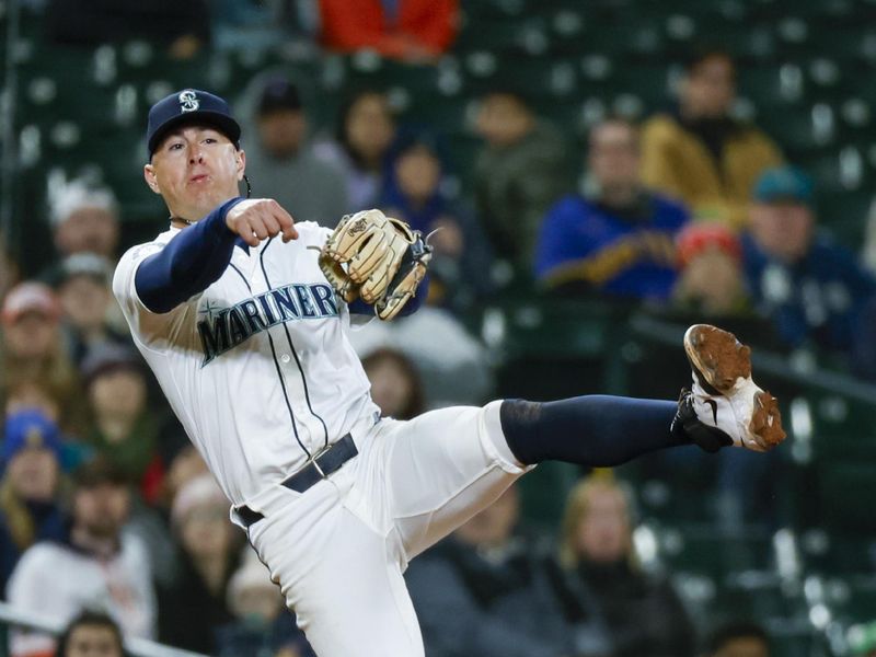 Apr 8, 2025; Seattle, Washington, USA; Seattle Mariners third baseman Dylan Moore (25) throws to first base for a double play to end the top of the eleventh inning against the Houston Astros at T-Mobile Park. Mandatory Credit: Joe Nicholson-Imagn Images