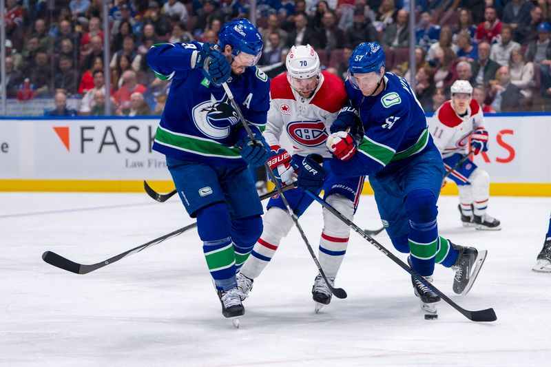 Mar 21, 2024; Vancouver, British Columbia, CAN; Vancouver Canucks forward J.T. Miller (9) and defenseman Tyler Myers (57) check Montreal Canadiens forward Tanner Pearson (70) in the second period at Rogers Arena. Mandatory Credit: Bob Frid-USA TODAY Sports