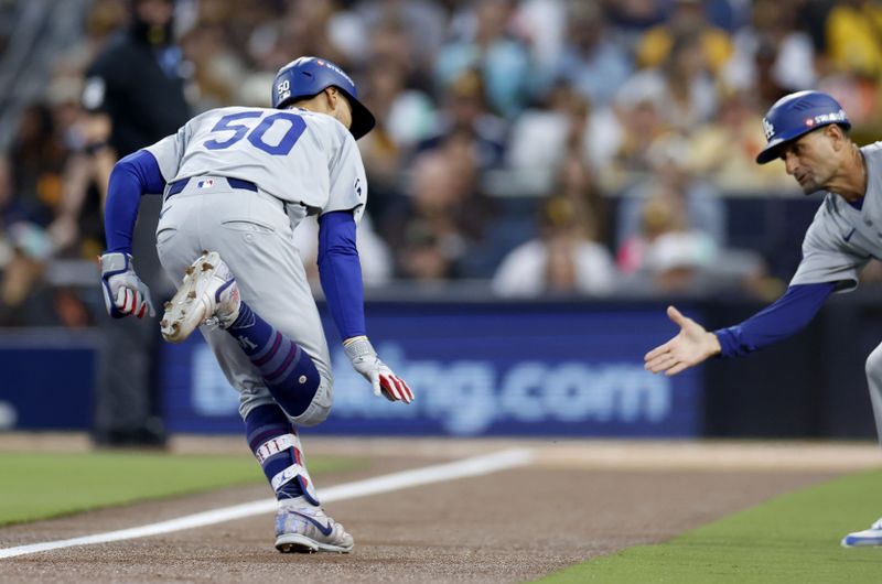 Oct 9, 2024; San Diego, California, USA; Los Angeles Dodgers shortstop Mookie Betts (50) celebrates with third base coach Dino Ebel (91) after hitting a home run in the first inning against the San Diego Padres during game four of the NLDS for the 2024 MLB Playoffs at Petco Park. Mandatory Credit: David Frerker-Imagn Images