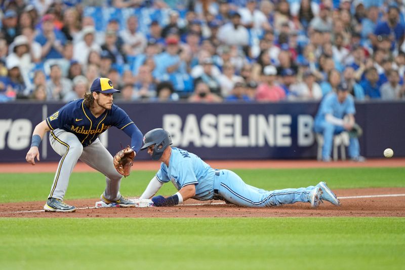 May 30, 2023; Toronto, Ontario, CAN; Toronto Blue Jays left fielder Whit Merrifield (15) slides safely against Milwaukee Brewers third baseman Brian Anderson (9) during the third inning at Rogers Centre. Mandatory Credit: John E. Sokolowski-USA TODAY Sports