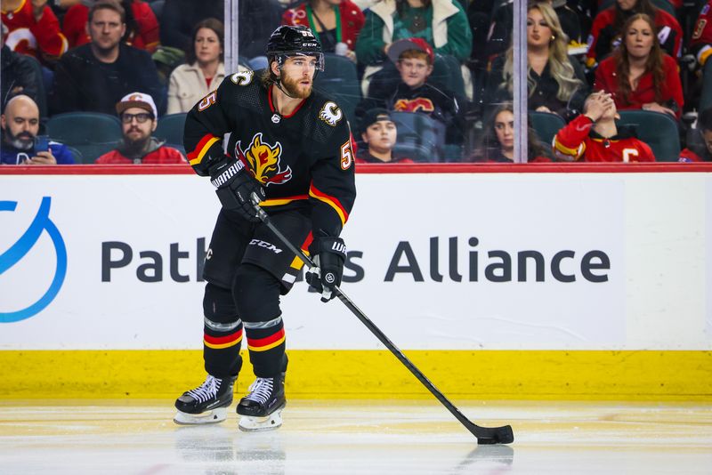 Dec 2, 2023; Calgary, Alberta, CAN; Calgary Flames defenseman Noah Hanifin (55) skates with the puck against the Vancouver Canucks during the third period at Scotiabank Saddledome. Mandatory Credit: Sergei Belski-USA TODAY Sports