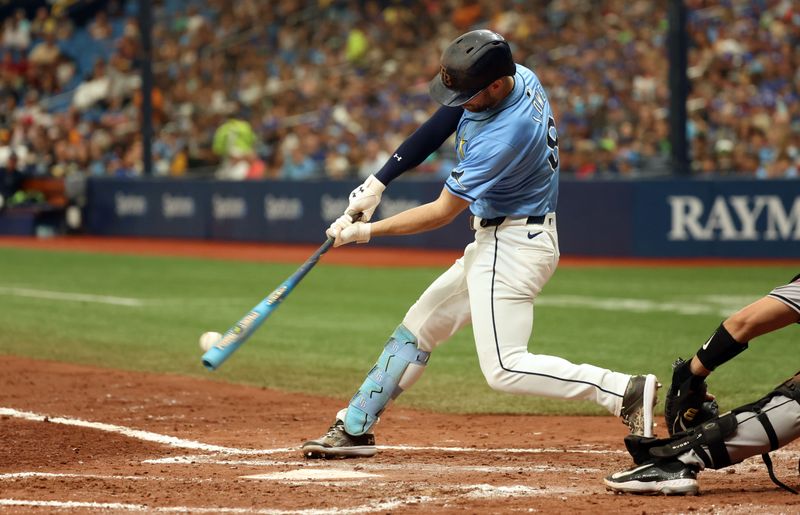 Aug 18, 2024; St. Petersburg, Florida, USA; Tampa Bay Rays designated hitter Brandon Lowe (8) singles against the Arizona Diamondbacks during the fifth inning at Tropicana Field. Mandatory Credit: Kim Klement Neitzel-USA TODAY Sports