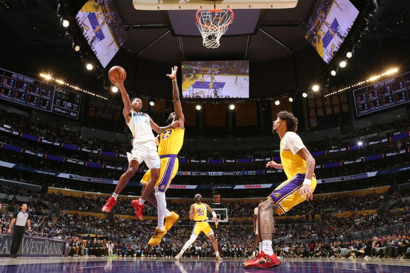 LOS ANGELES, CA - FEBRUARY 27:  Rob Dillingham #4 of the Minnesota Timberwolves shoots the ball during the game against the Los Angeles Lakers on February 27, 2025 at Crypto.Com Arena in Los Angeles, California. NOTE TO USER: User expressly acknowledges and agrees that, by downloading and/or using this Photograph, user is consenting to the terms and conditions of the Getty Images License Agreement. Mandatory Copyright Notice: Copyright 2025 NBAE (Photo by Nathaniel S. Butler/NBAE via Getty Images)