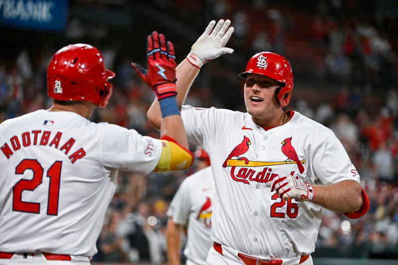 Aug 21, 2024; St. Louis, Missouri, USA;  St. Louis Cardinals pinch hitter Luken Baker (26) is congratulated by center fielder Lars Nootbaar (21) after hitting a two run home run against the Milwaukee Brewers during the seventh inning at Busch Stadium. Mandatory Credit: Jeff Curry-USA TODAY Sports