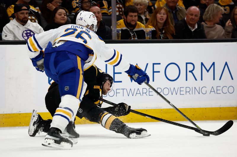 Oct 11, 2025; Boston, Massachusetts, USA; Boston Bruins left wing Tanner Jeannot (84) battles for a loose puck while he’s down with Buffalo Sabres defenseman Rasmus Dahlin (26) during the first period at TD Garden. Mandatory Credit: Winslow Townson-Imagn Images