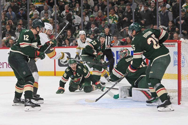 May 1, 2025; Saint Paul, Minnesota, USA;  Vegas Golden Knights forward Mark Stone (61) bats the puck out of mid-air and passed Minnesota Wild goalie Filip Gustavsson (32) for a goal as forward Matt Boldy (12) and defenseman Jonas Brodin (25) defend during the third period in game six of the first round of the 2025 Stanley Cup Playoffs at Xcel Energy Center. Mandatory Credit: Nick Wosika-Imagn Images