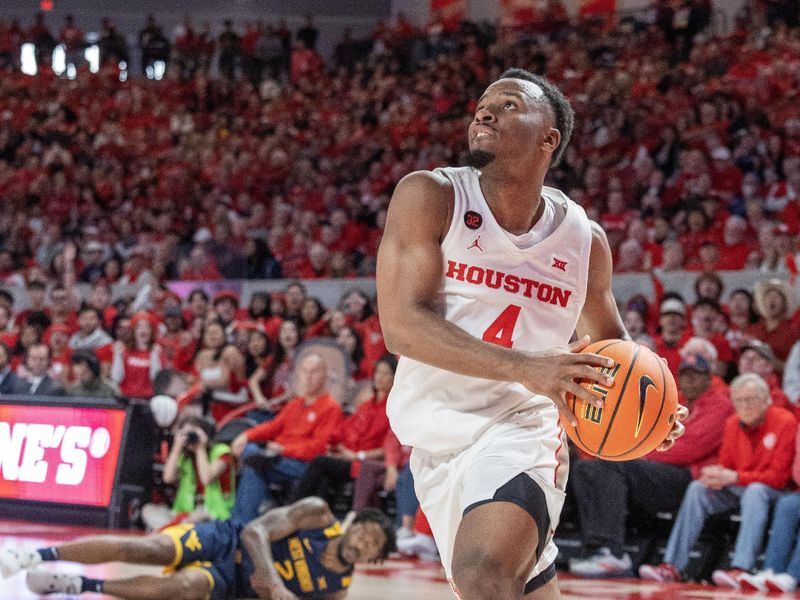 Jan 6, 2024; Houston, Texas, USA; Houston Cougars guard L.J. Cryer (4) dribbles past West Virginia Mountaineers guard Kobe Johnson (2) in the second half at Fertitta Center. Mandatory Credit: Thomas Shea-USA TODAY Sports