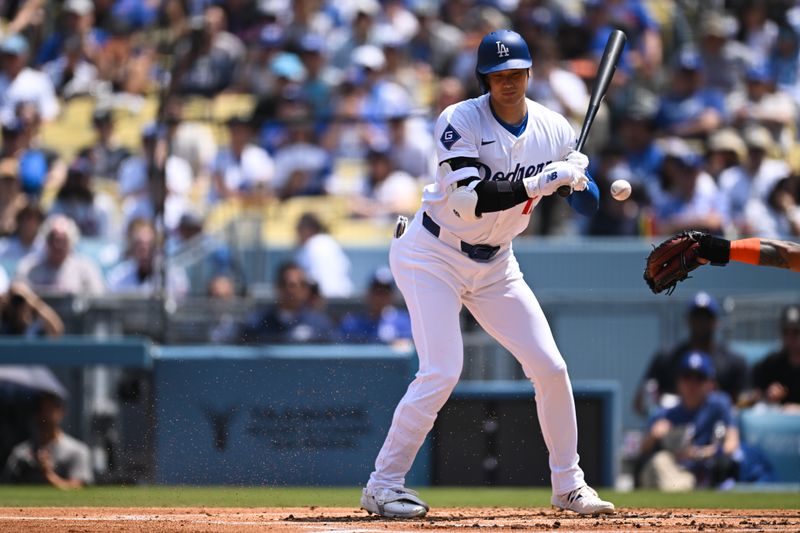 Apr 20, 2024; Los Angeles, California, USA; Los Angeles Dodgers designated hitter Shohei Ohtani (17) gets walked against the New York Mets during the first inning at Dodger Stadium. Mandatory Credit: Jonathan Hui-USA TODAY Sports