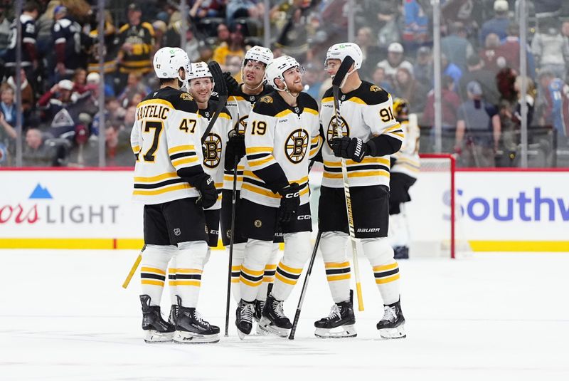 Oct 16, 2024; Denver, Colorado, USA; Boston Bruins center John Beecher (19) celebrates his empty net goal and center Mark Kastelic (47), defenseman Nikita Zadorov (91), left wing Cole Koepke (45) and defenseman Brandon Carlo (25) in the third period against the Colorado Avalanche at Ball Arena. Mandatory Credit: Ron Chenoy-Imagn Images