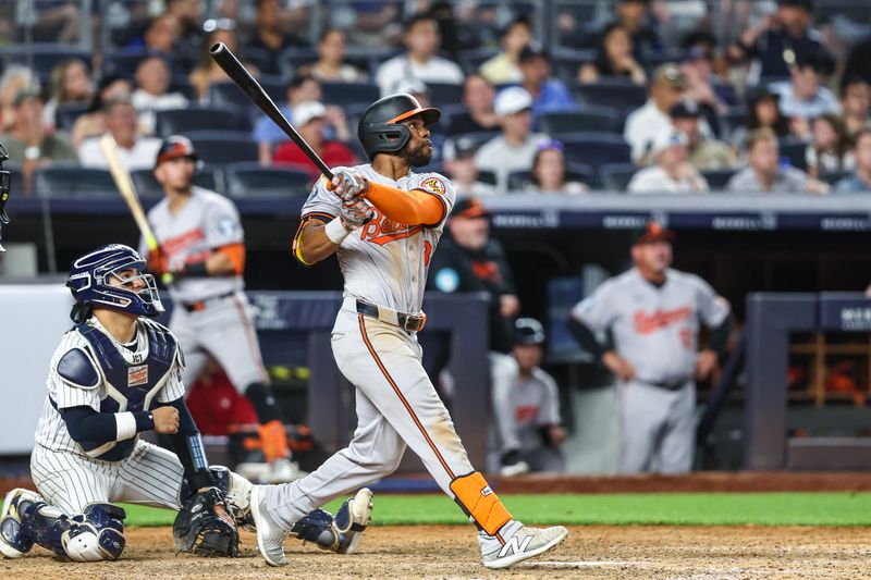 Jun 19, 2024; Bronx, New York, USA;  Baltimore Orioles center fielder Cedric Mullins (31) hits an RBI single in the tenth inning against the New York Yankees at Yankee Stadium. Mandatory Credit: Wendell Cruz-USA TODAY Sports