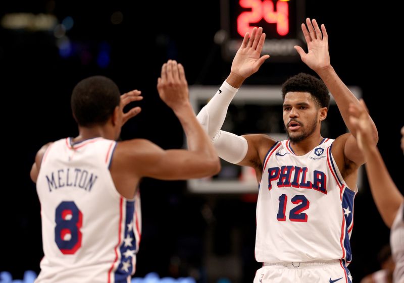 NEW YORK, NEW YORK - NOVEMBER 19:  De'Anthony Melton #8 of the Philadelphia 76ers is congratulated by teammate Tobias Harris #12 after Melton dunked in the second half against the Brooklyn Nets at Barclays Center on November 19, 2023 in the Brooklyn borough of New York City. The Philadelphia 76ers defeated the Brooklyn Nets 121-99. NOTE TO USER: User expressly acknowledges and agrees that, by downloading and or using this photograph, User is consenting to the terms and conditions of the Getty Images License Agreement. (Photo by Elsa/Getty Images)