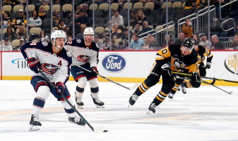 Oct 4, 2024; Pittsburgh, Pennsylvania, USA;  Columbus Blue Jackets center Cole Sillinger (4) moves the puck against the Pittsburgh Penguins during the second period at PPG Paints Arena. Mandatory Credit: Charles LeClaire-Imagn Images