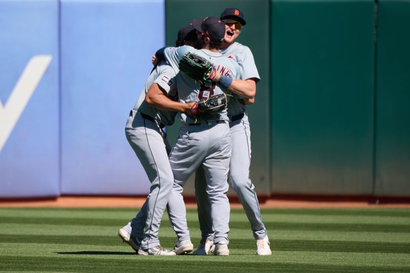 Sep 7, 2024; Oakland, California, USA; Detroit Tigers outfielders Matt Vierling (8) (obscured), Riley Greene (31) (obscured) and Parker Meadows (22) (right) celebrate after the last out of the game against the Oakland Athletics at Oakland-Alameda County Coliseum. Mandatory Credit: Robert Edwards-Imagn Images