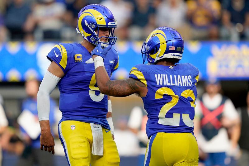 Los Angeles Rams running back Kyren Williams (23) celebrates his rushing touchdown with quarterback Matthew Stafford (9) during the second half of an NFL football game against the Arizona Cardinals Sunday, Oct. 15, 2023, in Inglewood, Calif. (AP Photo/Ryan Sun)