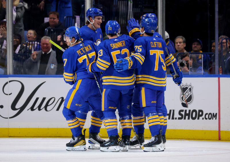 Nov 10, 2023; Buffalo, New York, USA;  Buffalo Sabres right wing JJ Peterka (77) celebrates his goal with teammates during the third period against the Minnesota Wild at KeyBank Center. Mandatory Credit: Timothy T. Ludwig-USA TODAY Sports