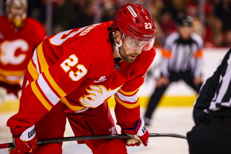 Jan 5, 2026; Calgary, Alberta, CAN; Calgary Flames center Justin Kirkland (23) during the face off against the Seattle Kraken during the third period at Scotiabank Saddledome. Mandatory Credit: Sergei Belski-Imagn Images