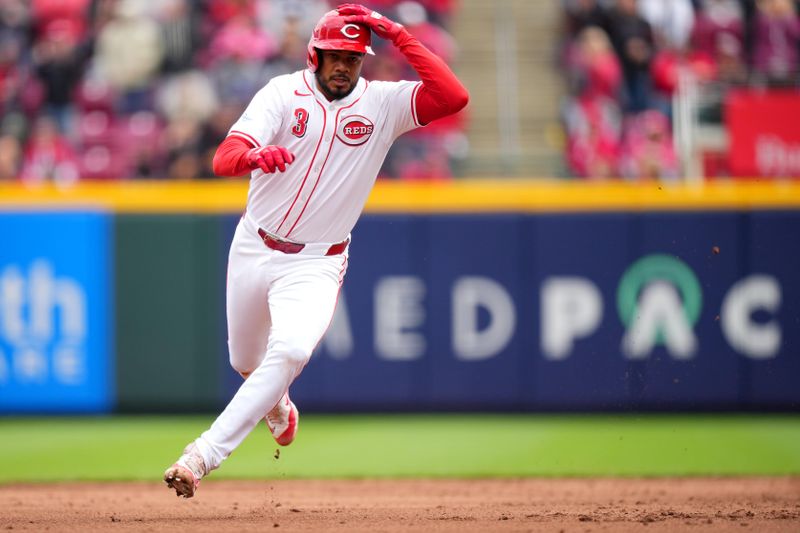 April 21, 2024; Cincinnati, Ohio, USA;  Cincinnati Reds third base Jeimer Candelario (3) rounds second base after hitting a triple, scoring Cincinnati Reds first base Christian Encarnacion-Strand (33), in the sixth inning at Great American Ball Park. Mandatory Credit: Kareem Elgazzar/USA TODAY Sports via The Cincinnati Enquirer

