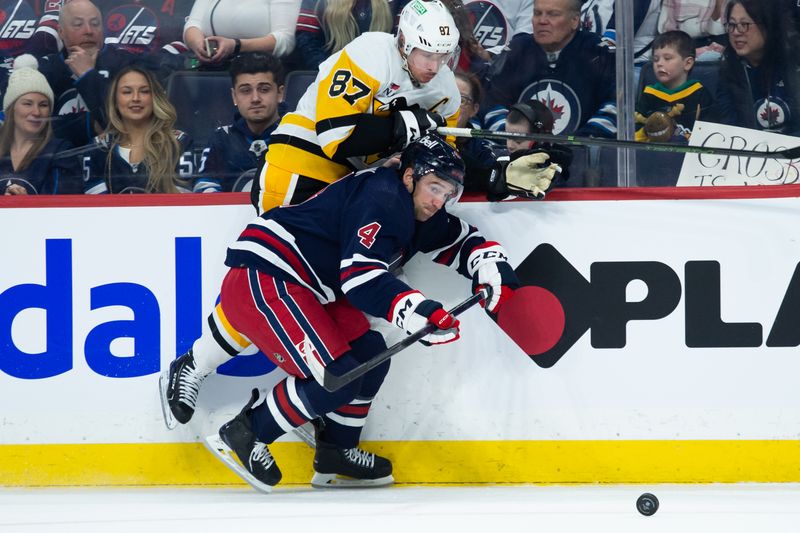 Feb 10, 2024; Winnipeg, Manitoba, CAN;  Winnipeg Jets defenseman Neal Pionk (4) and Pittsburgh Penguins forward Sidney Crosby (87) skate after the puck during the first period at Canada Life Centre. Mandatory Credit: Terrence Lee-USA TODAY Sports