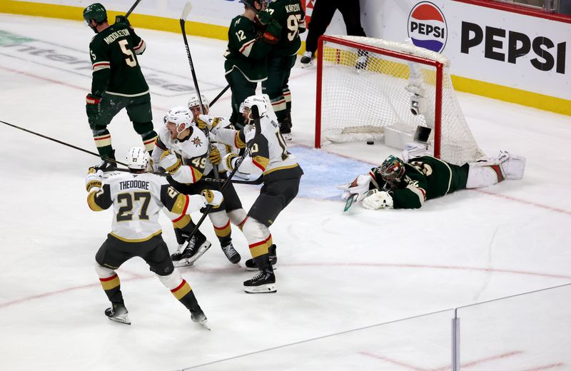 Apr 26, 2025; Saint Paul, Minnesota, USA; Vegas Golden Knights center Ivan Barbashev (49) celebrates with teammates after he puts the puck past Minnesota Wild goaltender Filip Gustavsson (32) during 1st OT in game four of the first round of the 2025 Stanley Cup Playoffs at Xcel Energy Center. Vegas Golden Knights win 4-3. Mandatory Credit: Bruce Fedyck-Imagn Images