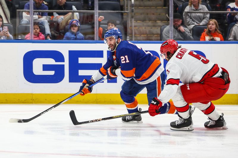 Apr 27, 2024; Elmont, New York, USA; New York Islanders center Kyle Palmieri (21) skates past Carolina Hurricanes defenseman Jalen Chatfield (5) in the second period in game four of the first round of the 2024 Stanley Cup Playoffs at UBS Arena. Mandatory Credit: Wendell Cruz-USA TODAY Sports