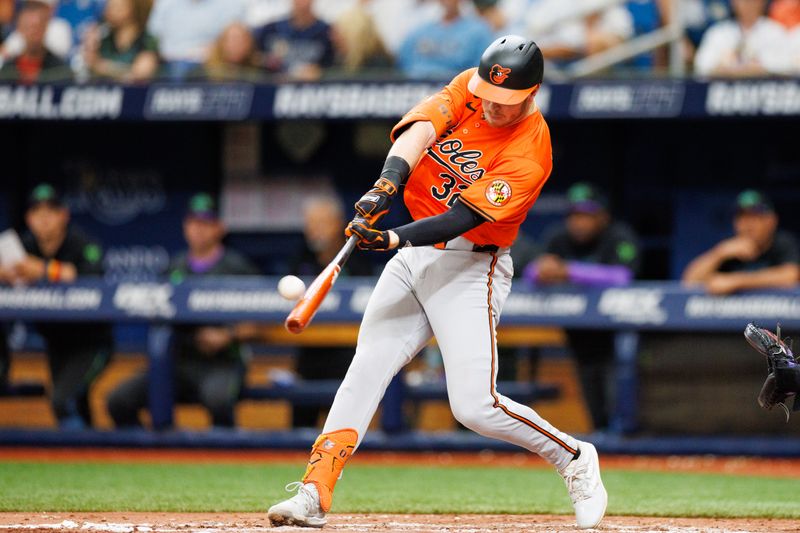 Jun 8, 2024; St. Petersburg, Florida, USA;  Baltimore Orioles outfielder Ryan O'Hearn (32) hits a solo home run against the Tampa Bay Rays in the fourth inning at Tropicana Field. Mandatory Credit: Nathan Ray Seebeck-USA TODAY Sports