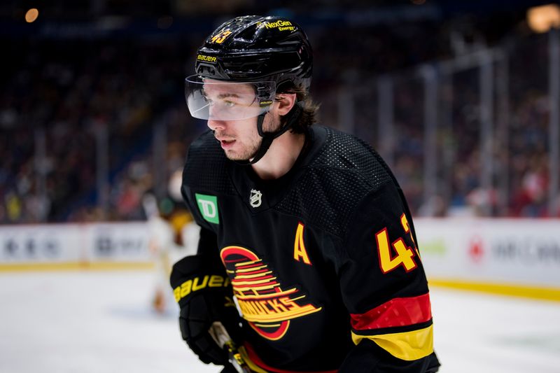 Feb 13, 2023; Vancouver, British Columbia, CAN; Vancouver Canucks defenseman Quinn Hughes (43) looks at the loose puck against the Detroit Red Wings in the second period at Rogers Arena. Mandatory Credit: Bob Frid-USA TODAY Sports