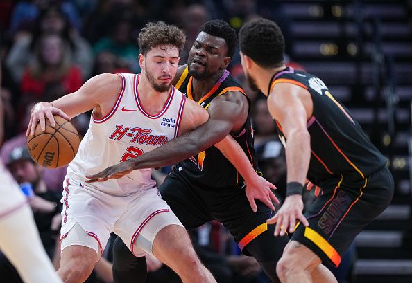 HOUSTON, TEXAS - DECEMBER 27: Alperen Sengun #28 of the Houston Rockets dribbles the ball as Udoka Azubuike #27 of the Phoenix Suns defends during the second quarter of the game at Toyota Center on December 27, 2023 in Houston, Texas. User expressly acknowledges and agrees that, by downloading and or using this photograph, User is consenting to the terms and conditions of the Getty Images License Agreement. (Photo by Alex Bierens de Haan/Getty Images)