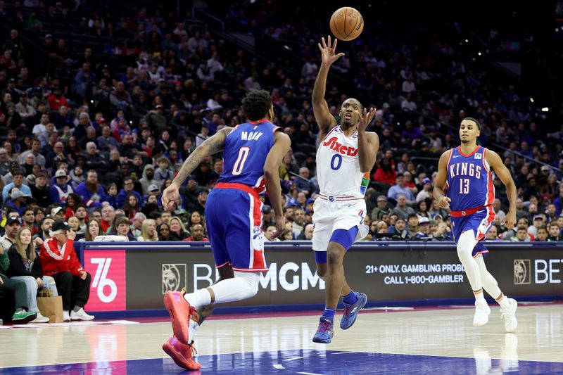 PHILADELPHIA, PENNSYLVANIA - JANUARY 29: Tyrese Maxey #0 of the Philadelphia 76ers passes the ball against Malik Monk #0 of the Sacramento Kings during the first half at the Wells Fargo Center on January 29, 2025 in Philadelphia, Pennsylvania. NOTE TO USER: User expressly acknowledges and agrees that, by downloading and or using this photograph, User is consenting to the terms and conditions of the Getty Images License Agreement. (Photo by Emilee Chinn/Getty Images)