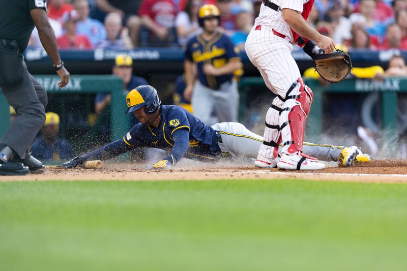 Jun 4, 2024; Philadelphia, Pennsylvania, USA; Milwaukee Brewers outfielder Blake Perkins (16) scores past Philadelphia Phillies catcher J.T. Realmuto (10) during the third inning at Citizens Bank Park. Mandatory Credit: Bill Streicher-USA TODAY Sports