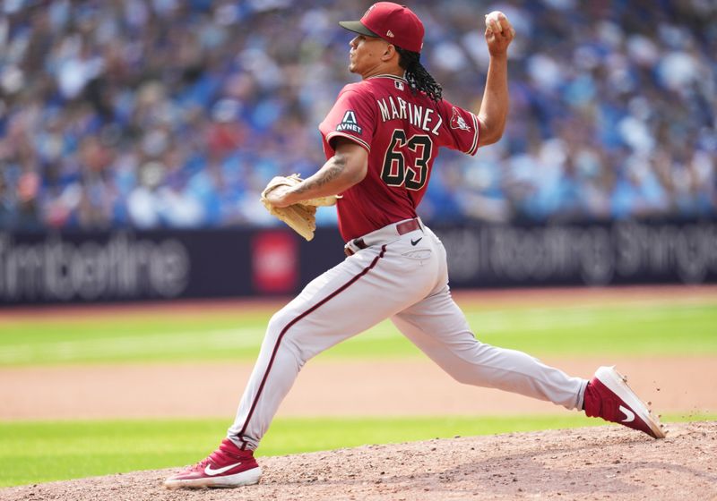 Jul 16, 2023; Toronto, Ontario, CAN; Arizona Diamondbacks relief pitcher Justin Martinez (63) throws a pitch against the Toronto Blue Jays during the eighth inning at Rogers Centre. Mandatory Credit: Nick Turchiaro-USA TODAY Sports