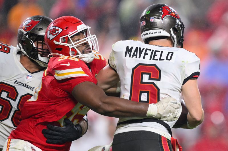 Kansas City Chiefs defensive tackle Chris Jones, left, pressures Tampa Bay Buccaneers quarterback Baker Mayfield (6) during the second half of an NFL football game, Monday, Nov. 4, 2024 in Kansas City, Mo. The Chiefs defeated the Buccaneers, 30-24. (AP Photo/Reed Hoffmann)