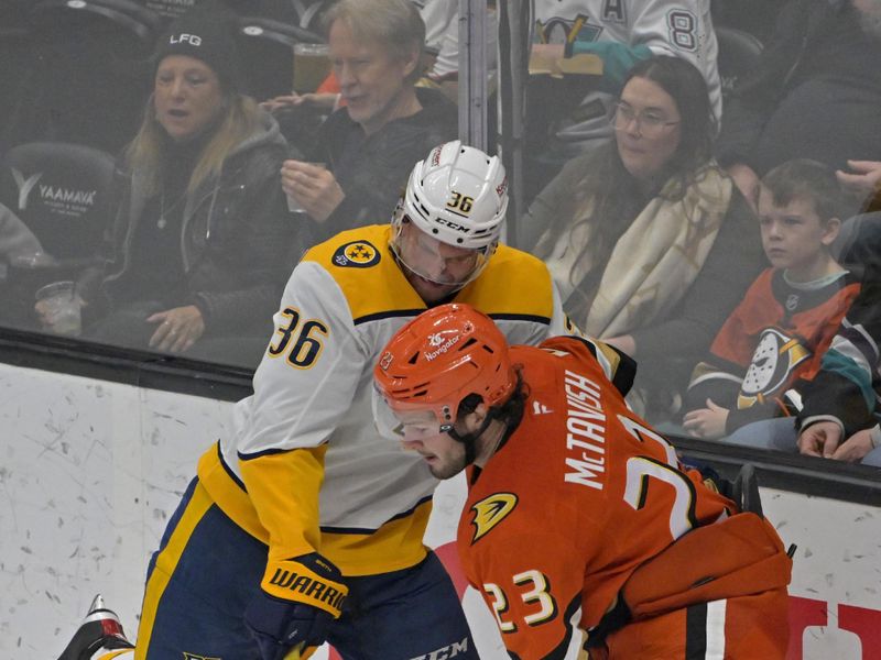 Jan 25, 2025; Anaheim, California, USA; Nashville Predators left wing Cole Smith (36) and Anaheim Ducks center Mason McTavish (23) go for the puck in the second period at Honda Center. Mandatory Credit: Jayne Kamin-Oncea-Imagn Images