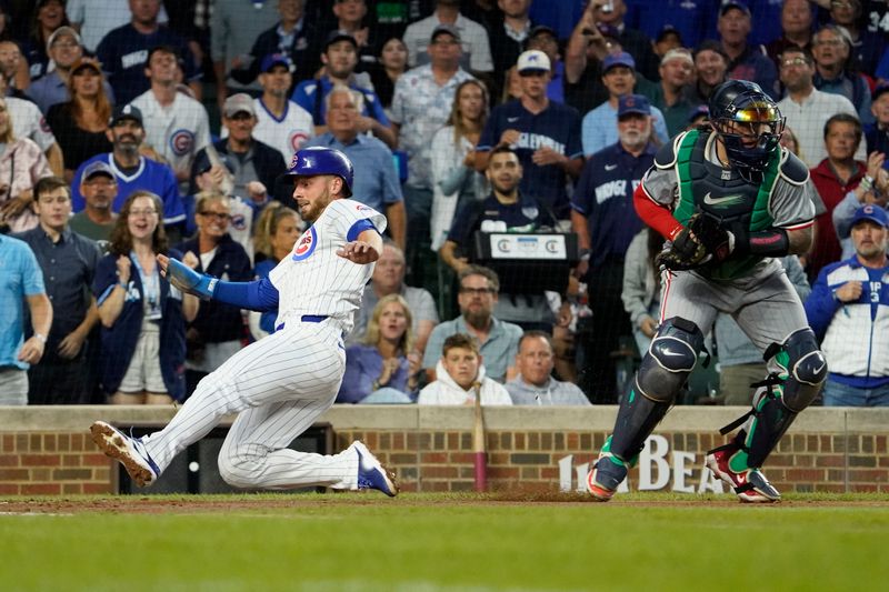 Aug 6, 2024; Chicago, Illinois, USA; Chicago Cubs first baseman Michael Busch (29) is safe at home plate as Minnesota Twins catcher Christian Vázquez (8) takes a late throw during the fourth inning at Wrigley Field. Mandatory Credit: David Banks-USA TODAY Sports