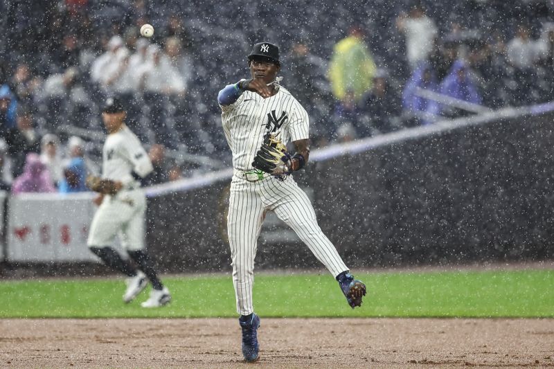 Aug 8, 2024; Bronx, New York, USA;  New York Yankees third baseman Jazz Chisholm Jr. (13) makes a running throw to first base in the ninth inning against the Los Angeles Angels at Yankee Stadium. Mandatory Credit: Wendell Cruz-USA TODAY Sports