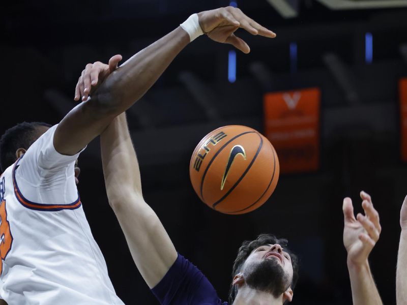 Nov 28, 2025; Charlottesville, Virginia, USA; Virginia Cavaliers center Ugonna Onyenso (33) knocks the ball away from Queens University of Charlotte Royals forward Gus Larson (7) during the first half at John Paul Jones Arena. Mandatory Credit: Amber Searls-Imagn Images