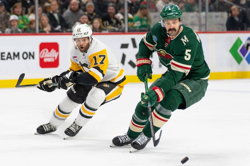 Feb 9, 2024; Saint Paul, Minnesota, USA; Minnesota Wild defenseman Jake Middleton (5) steals the puck from Pittsburgh Penguins right wing Bryan Rust (17) in the first period at Xcel Energy Center. Mandatory Credit: Matt Blewett-USA TODAY Sports